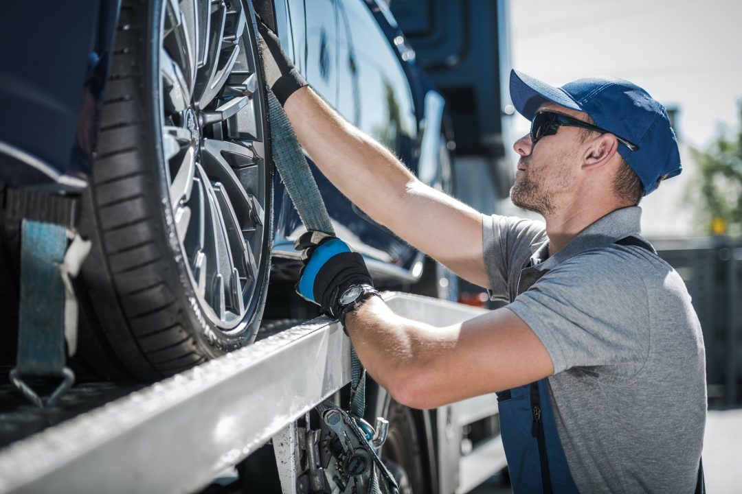 towing-truck-driver-securing-transported-vehicle.jpg