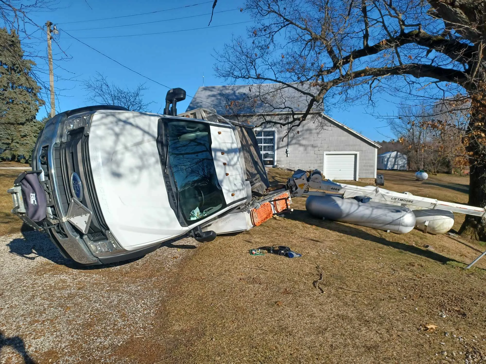 Rolled-over truck and boat during accident recovery in Benton Harbor, MI