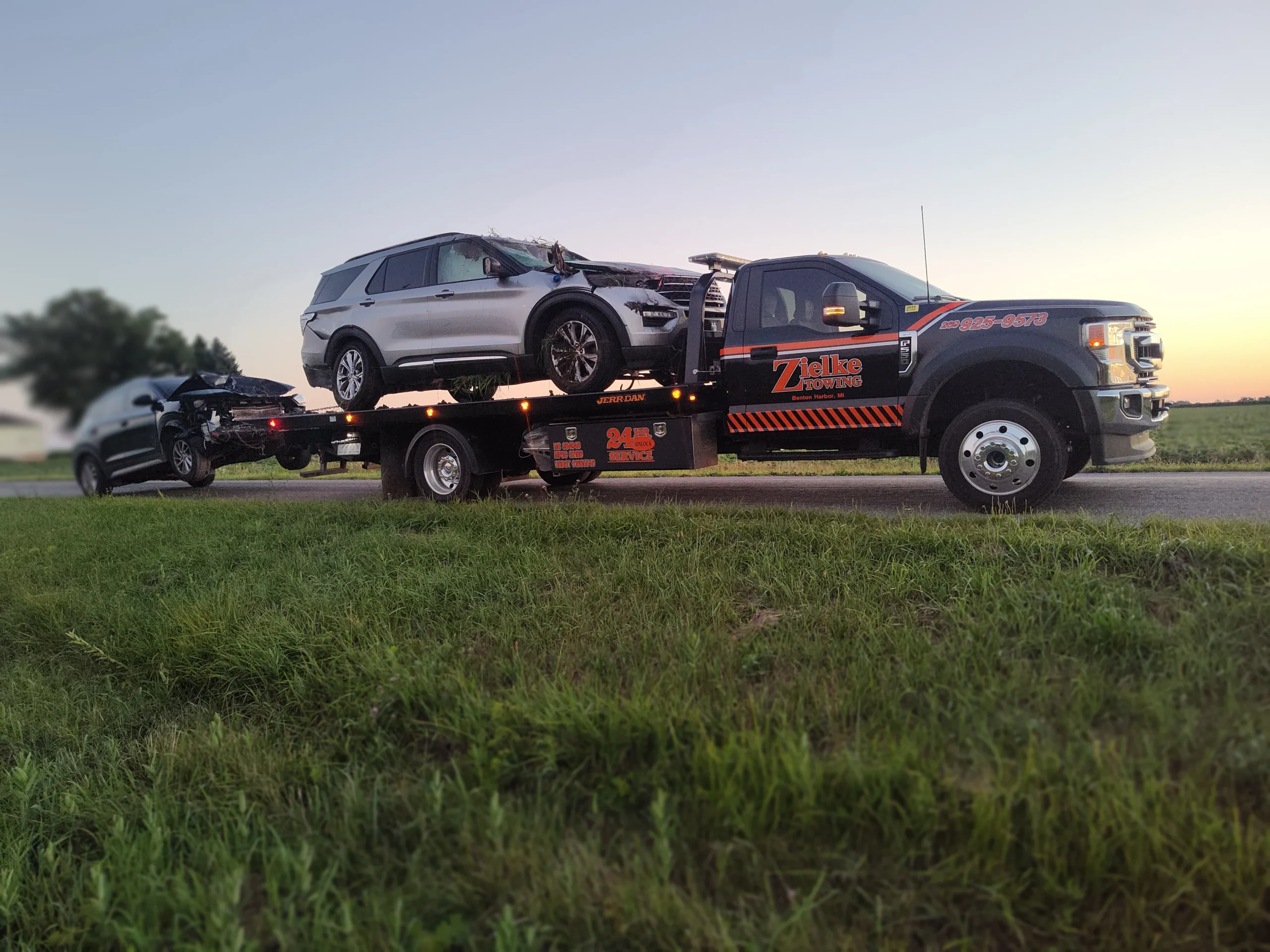Zielke flatbed towing two damaged vehicles near Benton Harbor, Michigan