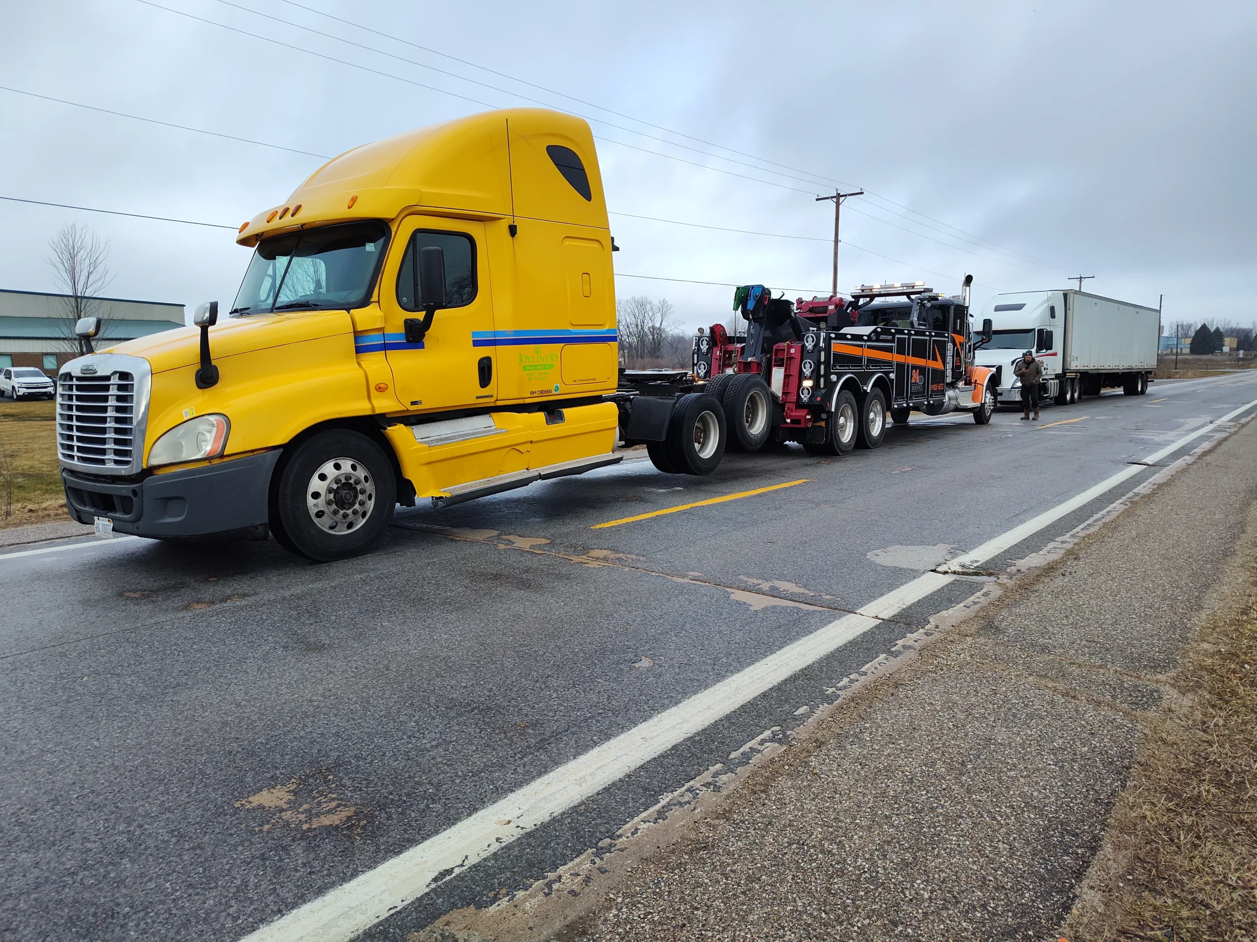 Zielke heavy-duty wrecker towing disabled semi-truck on highway in Benton Harbor, MI