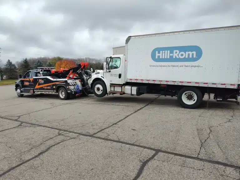 Zielke Towing service hooked up to a Hill-Rom delivery truck for heavy duty towing in Michigan