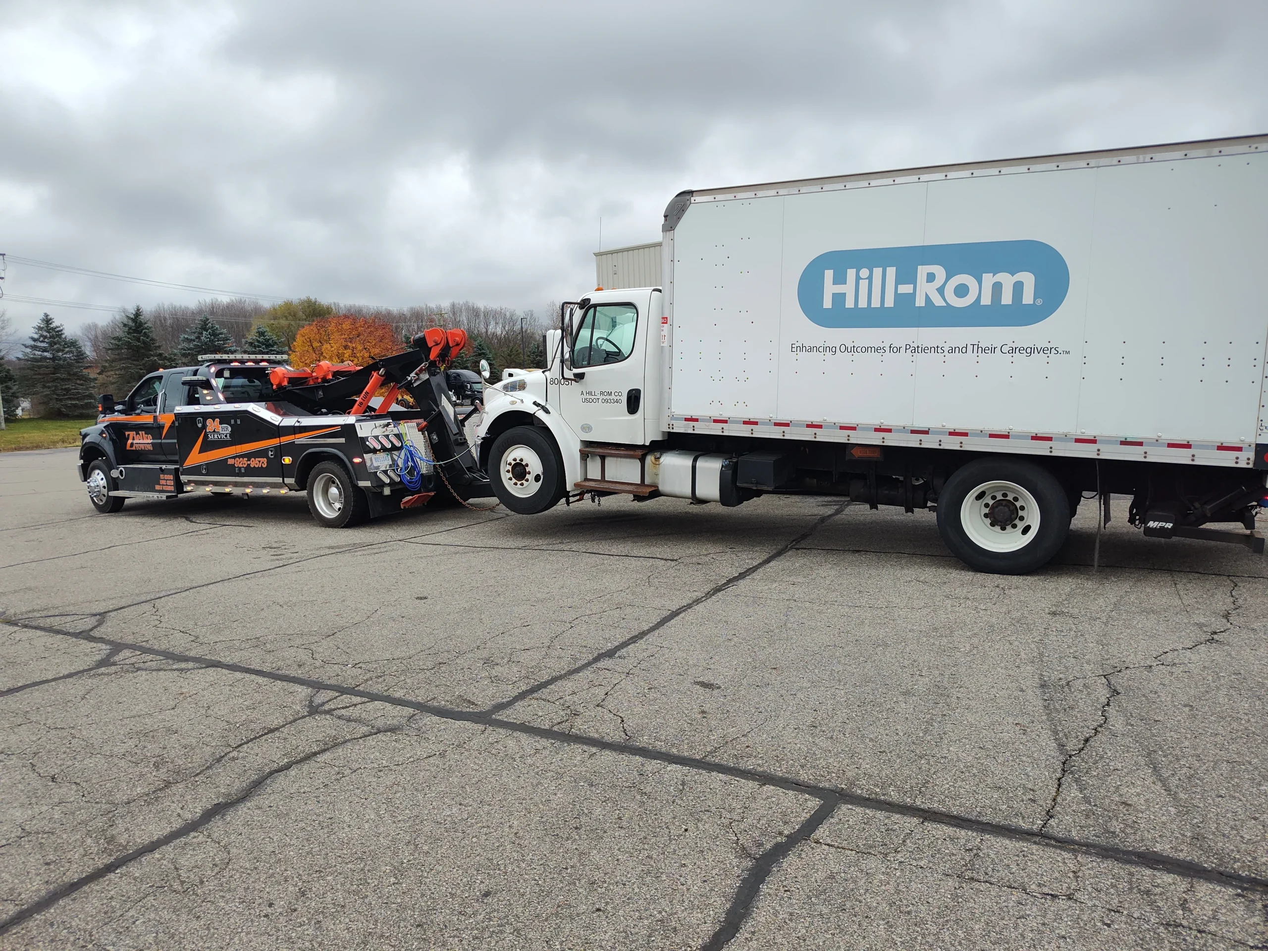 Zielke Towing service hooked up to a Hill-Rom delivery truck for heavy duty towing in Michigan