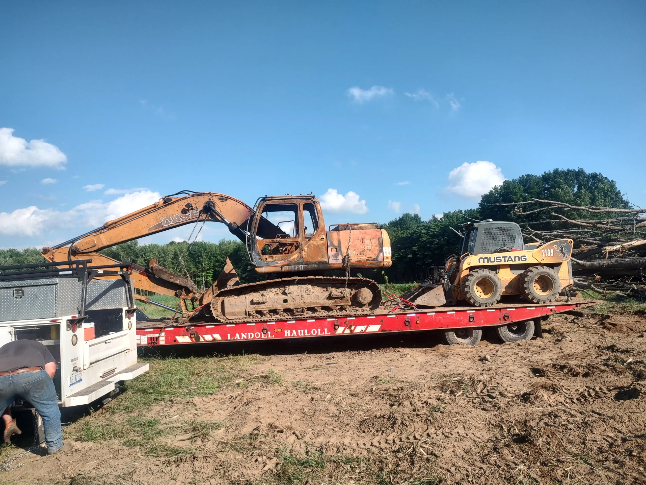 Zielke Towing assisting with muddy off-road winch out of heavy equipment near Benton Harbor