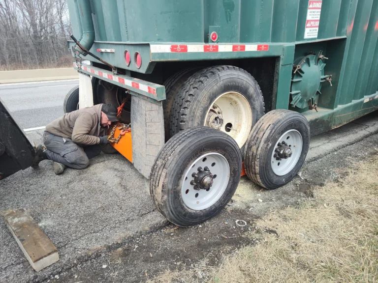 Zielke Towing technician replacing a blown tire on a semi-trailer roadside in Benton Harbor, MI