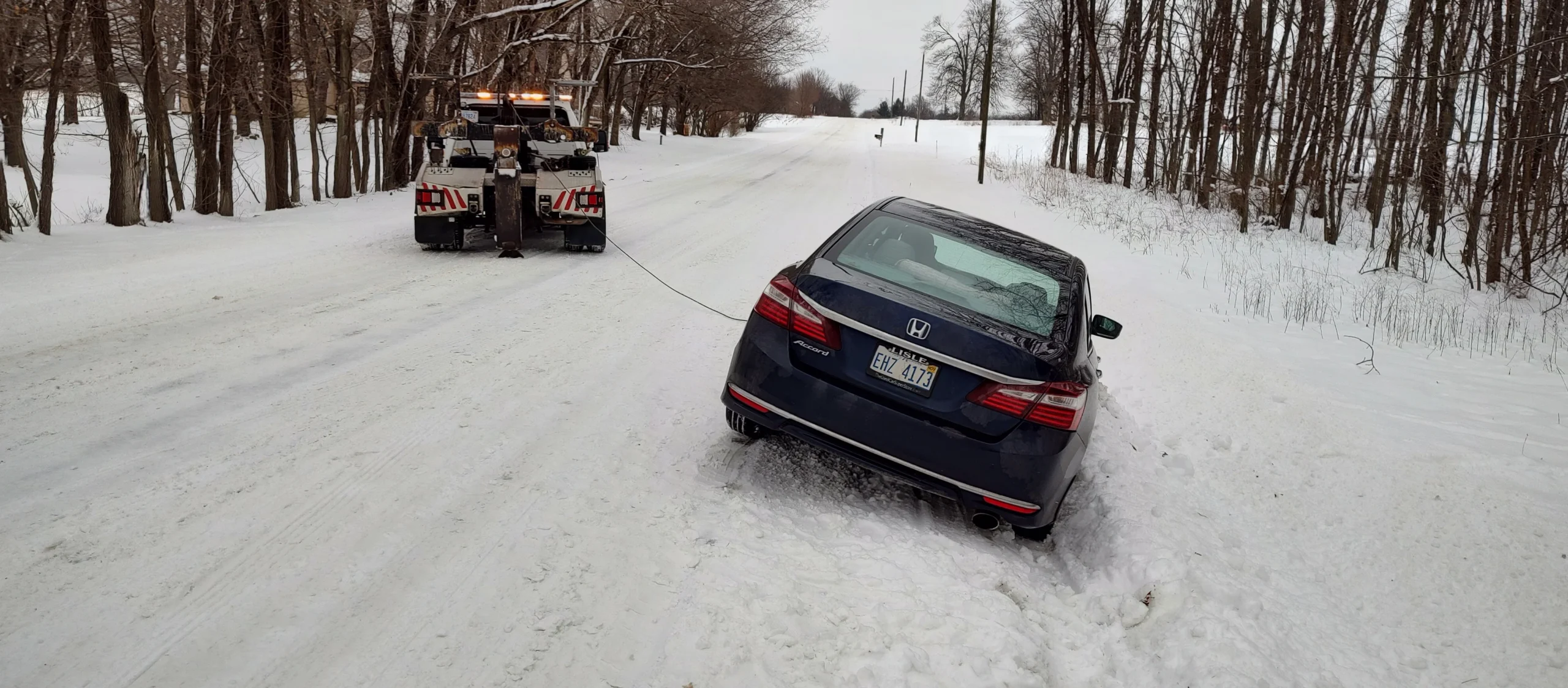 Zielke Towing truck pulling stuck car from snowbank in Benton Harbor, MI