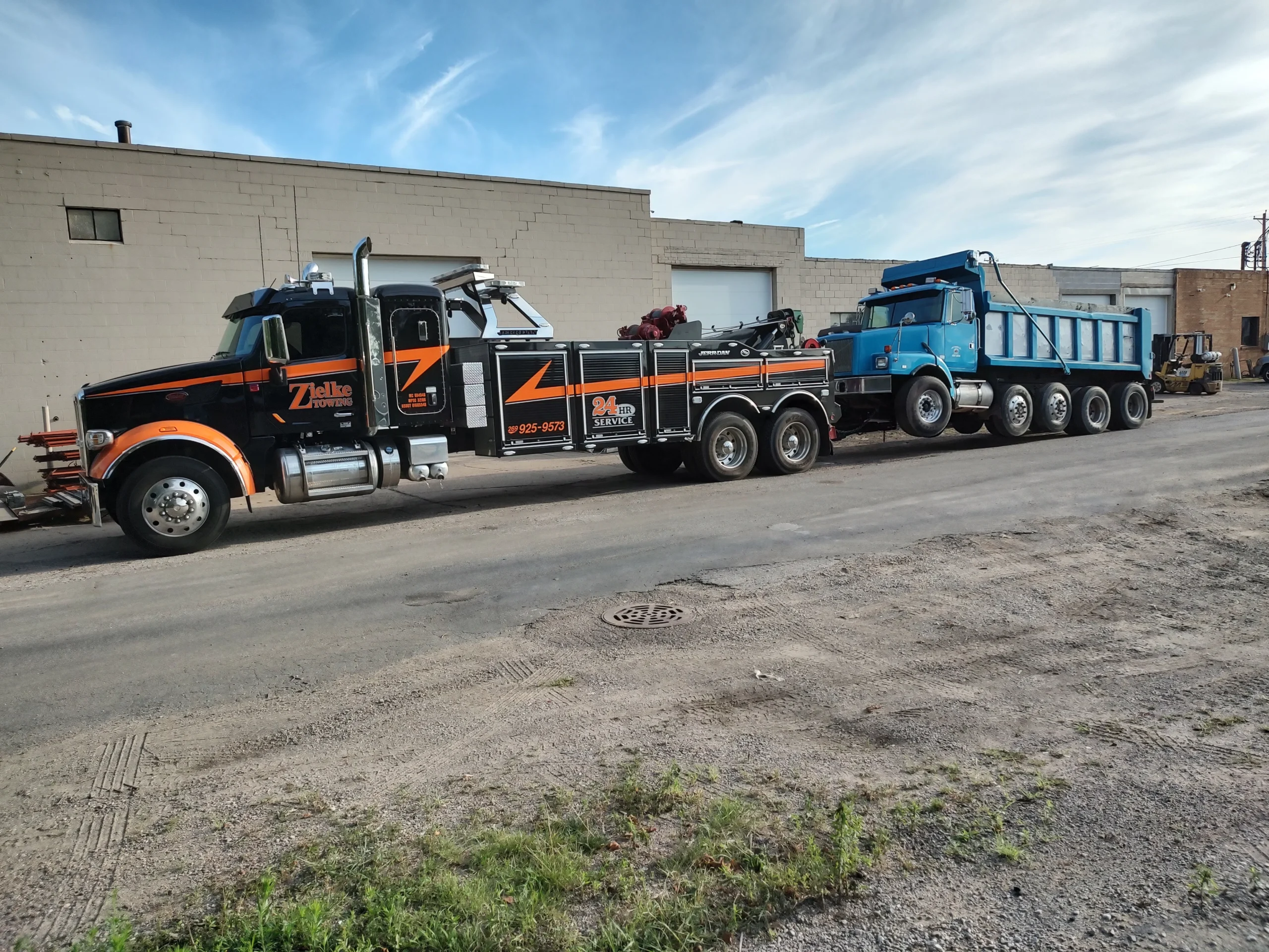 Zielke Towing hauling a broken-down dump truck in Benton Harbor, MI