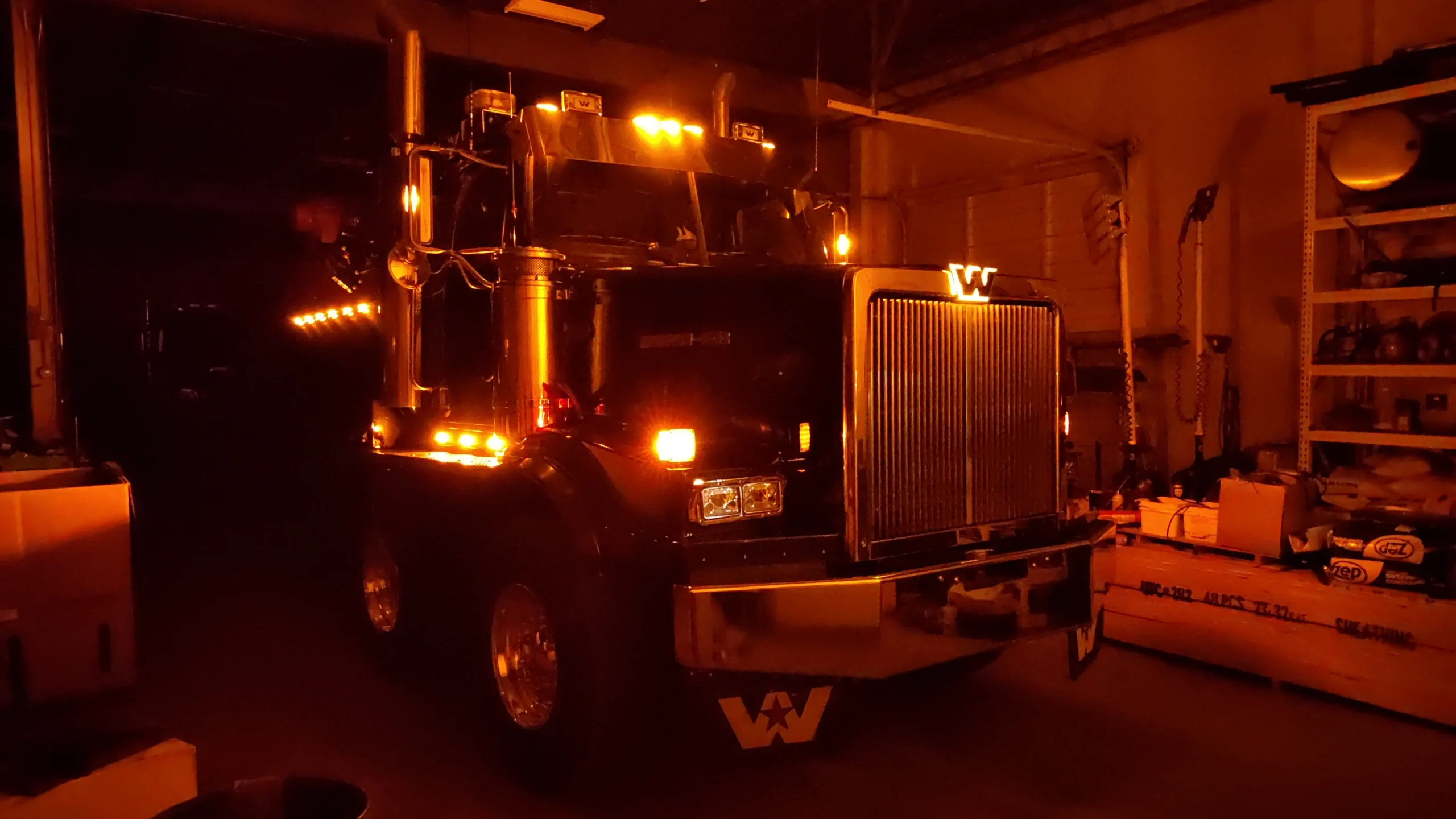 Western Star truck lit up for electrical inspection in Zielke Towing’s service garage with amber lights glowing