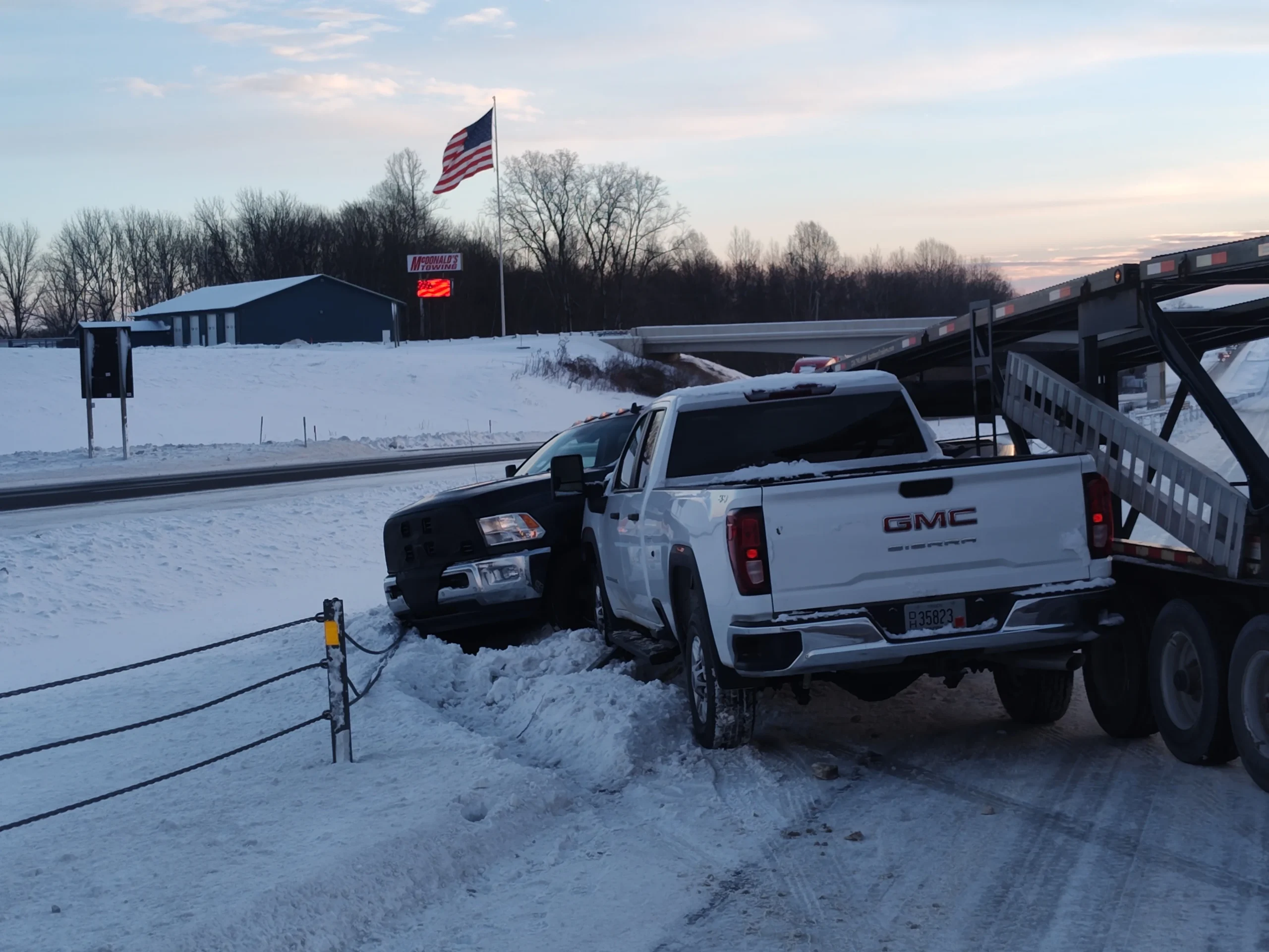 Zielke Towing performing winch out service for trucks stuck in snow near Benton Harbor highway
