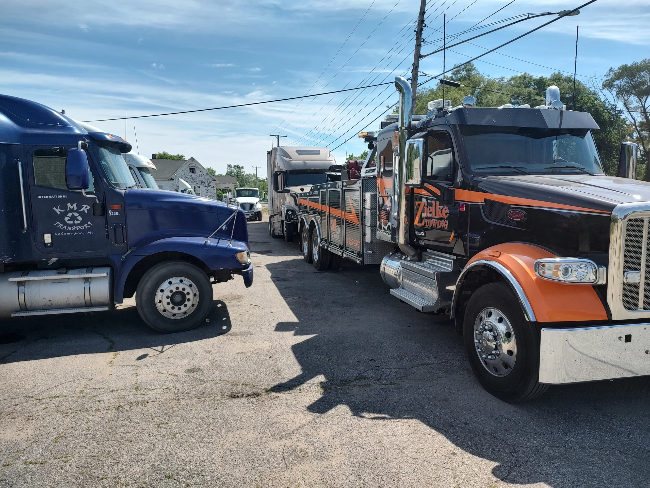 Zielke Towing heavy-duty wrecker truck connecting to a blue semi for transmission-related towing near Benton Harbor, Michigan