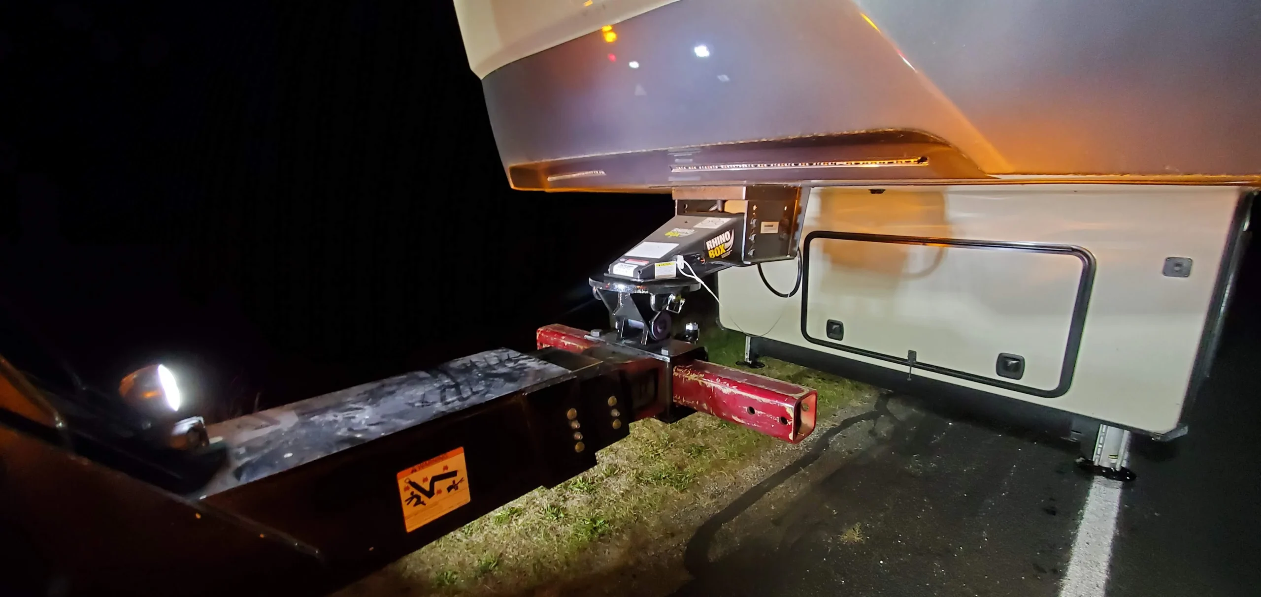 Night towing scene showing Zielke wheel lift towing connection on RV fifth wheel trailer hitch