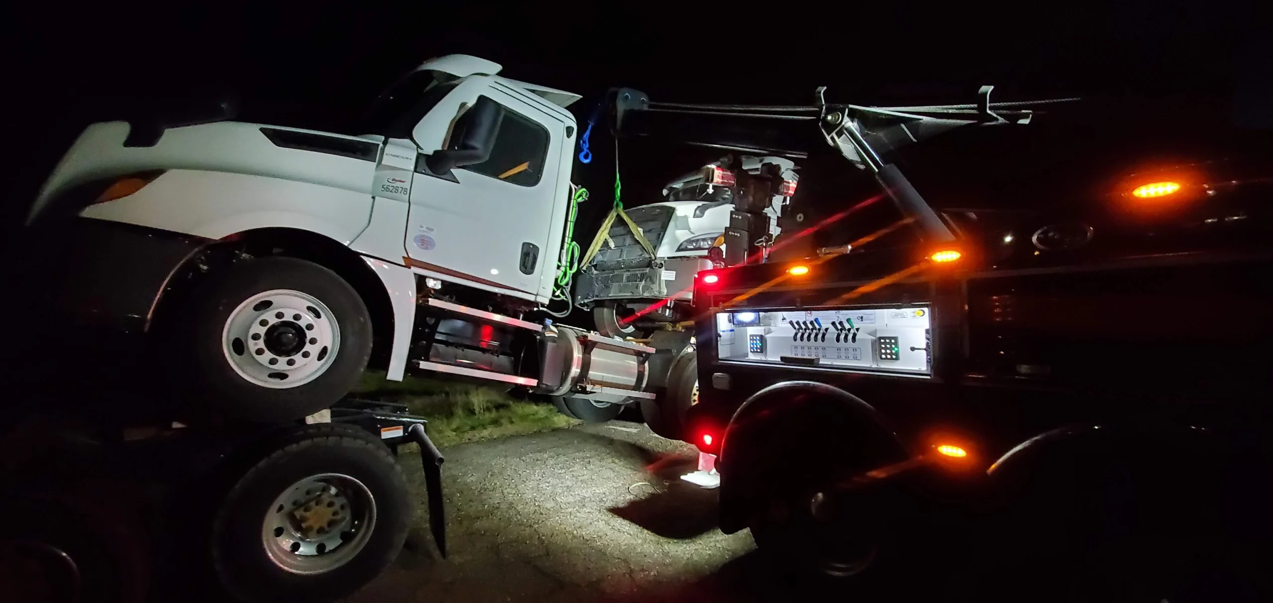 Zielke Towing provides expert wheel lift towing on broken down semi-tractor at night roadside stop