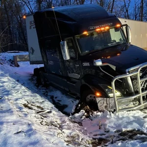 Semi-truck stuck in snow needing battery or climate control service in Benton Harbor