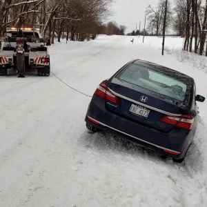 Zielke Towing truck pulling stuck car from snowbank in Benton Harbor, MI